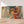Première image de la peinture par numéro, Chouettes en Mosaïque , dans un cadre en bois sur du parquet.