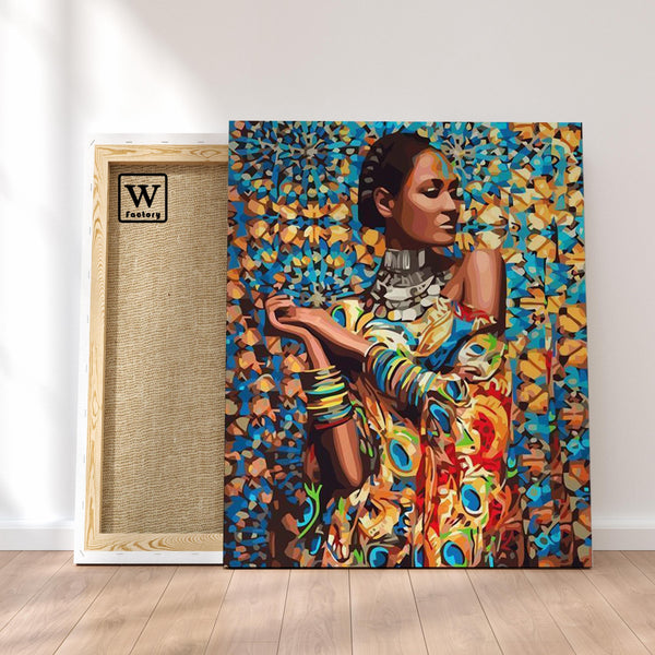 Première image de la peinture par numéro, Femme Africaine , dans un cadre en bois sur du parquet.