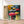 Première image de la peinture par numéro, Parapluies Multicolores , dans un cadre en bois sur du parquet.