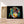 Charger l&#39;image dans la galerie, Première image de la peinture par numéro, Chimpanzé Coloré , dans un cadre en bois sur du parquet.
