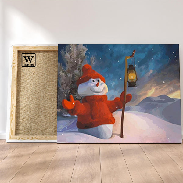 Première image de la peinture par numéro, Bonhomme de Neige , dans un cadre en bois sur du parquet.