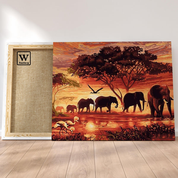 Première image de la peinture par numéro, Éléphants en Afrique , dans un cadre en bois sur du parquet.