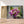 Charger l&#39;image dans la galerie, Première image de la peinture par numéro, Fleurs et Fenêtre , dans un cadre en bois sur du parquet.
