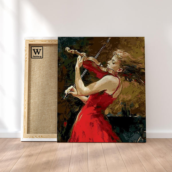 Première image de la peinture par numéro, Violoniste Rouge , dans un cadre en bois sur du parquet.